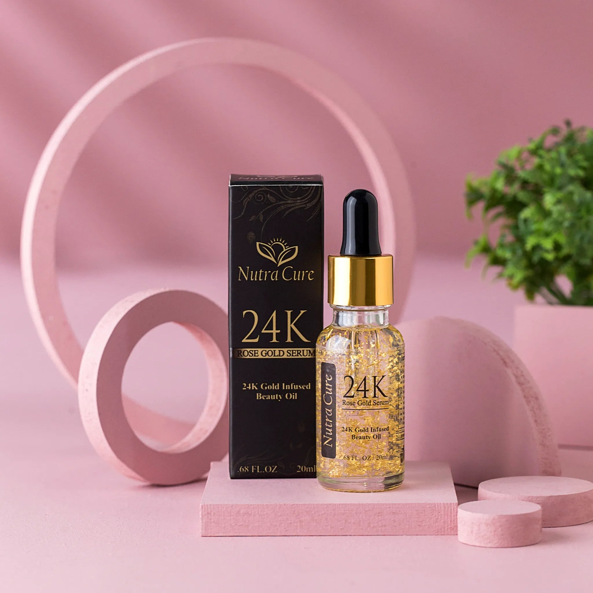 Nutra Cure 24K Rose Gold Beauty Oil anti-aging face serum bottle and matching product box displayed on a pink aesthetic platform